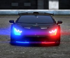 a blue sports car with its lights on