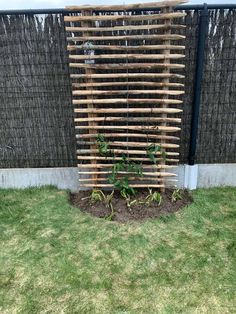 a fence made out of wood sticks and grass