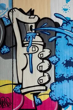 graffiti painted on the side of a building with blue spray paint and an image of a water faucet