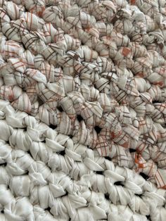 a pile of white and orange bags sitting on top of each other