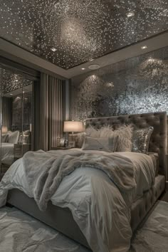 a large bed in a room with stars on the ceiling