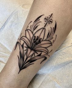 a black and white flower tattoo on the leg