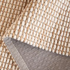 close up view of woven fabric with white and brown colors