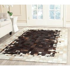 a large area rug with brown and white squares on it in front of a door