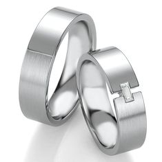 two white gold wedding rings on a white background