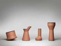 three vases and one bowl are shown in the same color as they appear to be made out of clay