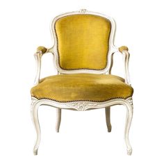 an old fashioned chair with yellow upholstered fabric and white trimmings on the back