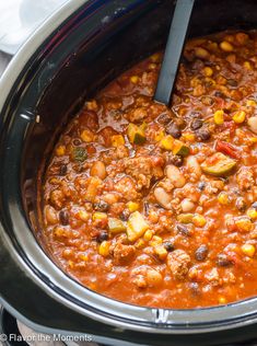 a slow cooker filled with chili and beans