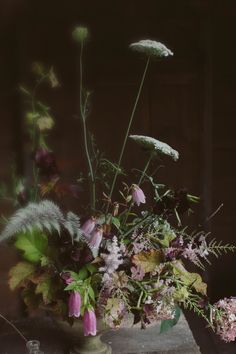 a vase filled with lots of flowers on top of a table