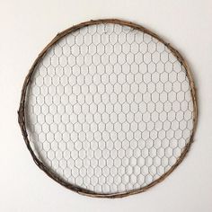 a white wall with a wire circle hanging on it