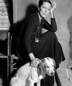 a black and white photo of a woman with a dog