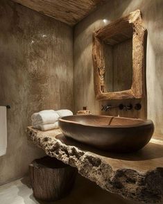 a bathroom with a large stone bowl sink