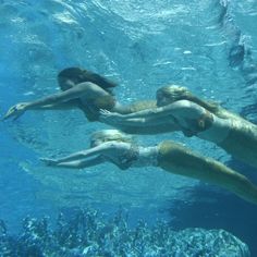 two women are swimming in the water