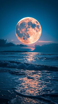 the full moon is shining brightly over the ocean