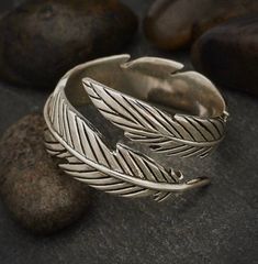 This is feather ring. Solid Sterling silver 925.The ring is an adjustable ring. It can comfortably fit sizes 6- 8.5Just some minor spreading apart does the trickSterling silver should be polished regularly, and it is not recommended to wear Sterling silver in water.