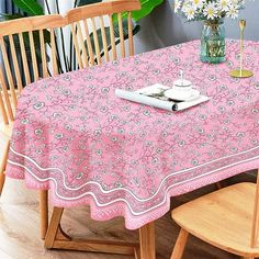 a pink table cloth with flowers on it