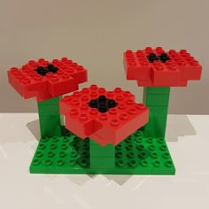 two legos made to look like they are sitting on top of each other in the shape of flowers