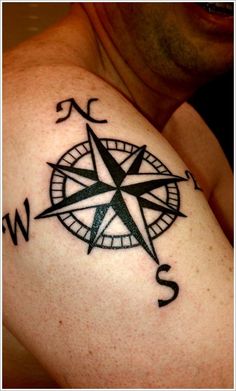 a man with a compass tattoo on his arm