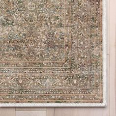 an antique rug is displayed on the floor in front of a wooden wall with wood paneling