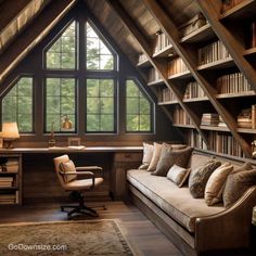 an attic office with bookshelves, desk and couch in the middle of it