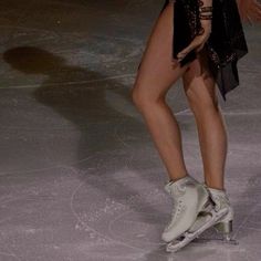 a female figure skating on an ice rink