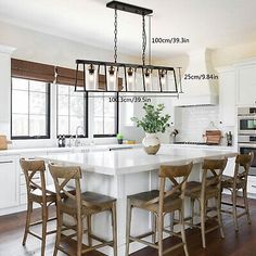 a kitchen island with four stools in front of it