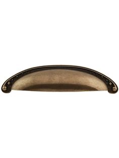 an antique brass drawer pull handle on a white background with clippings to the bottom