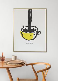 a table and chair with a poster on the wall above it that has a woman's legs in a bowl