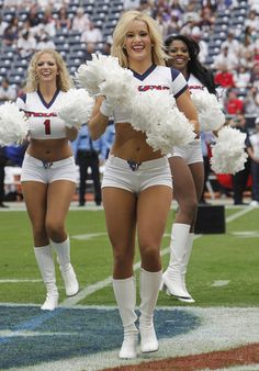 two cheerleaders are walking on the field