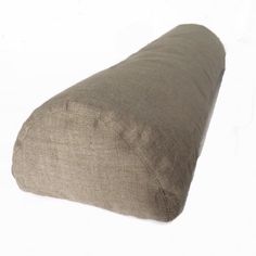 a pillow that is on top of a white surface with the bottom half rolled up