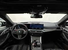 the inside of a car with dashboard and steering wheel