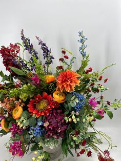 a vase filled with lots of colorful flowers