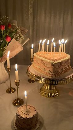 a table topped with a cake and candles