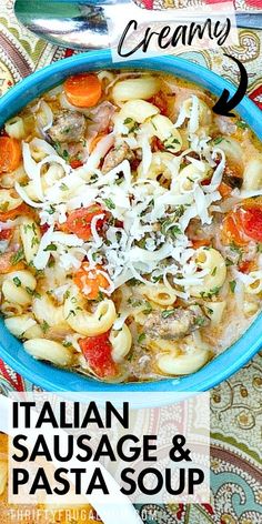 an italian sausage and pasta soup in a blue bowl with a spoon on the side