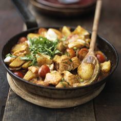 a bowl filled with food sitting on top of a wooden table