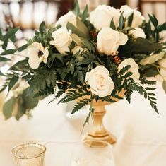 a vase filled with white flowers on top of a table