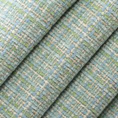 a close up shot of a blue and green tweed fabric