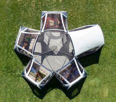 an upside down view of the inside of a tent with pictures in it on grass