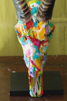 an animal's skull is covered in colorful paint