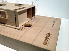 an architectural model of a house on top of a box with the word welcome written on it