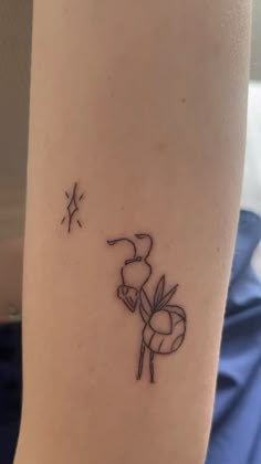 a small tattoo on the leg of a person with a star in the sky above it