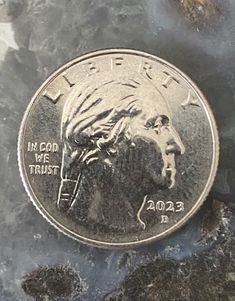 a coin sitting on top of some rocks