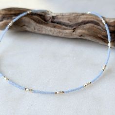 An ocean inspired combination of soft blue and classic freshwater pearls. These semi-transparent, matte sky blue glass beads have the most luxe look and feel to them. And they pair with classic freshwater pearls effortlessly. Colors: This beaded necklace features matte semi-transparent sky blue glass beads Gemstones: Superior AAA Grade Freshwater Pearl Length: Approximately 14.5" in length with a 2.5" extender chain (17" total length) Metal: 14k Gold Fill or Sterling SilverAll metal findings, be Beachy Seed Bead Necklace, Beach Beaded Necklace, Bead Bracelet Patterns, Surf Necklace, Seed Bead Bracelet Patterns, Preppy Jewelry, Beach Necklaces, Seed Bead Bracelet, Gold Alloys