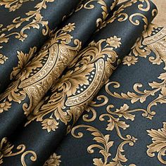 the black and gold wallpaper is next to a brown table cloth with an ornate design on it