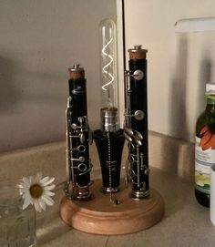 an assortment of musical instruments sitting on top of a counter next to a bottle of wine