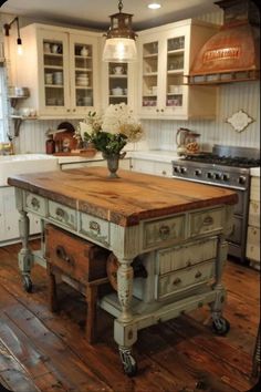 an old fashioned kitchen island with flowers on it