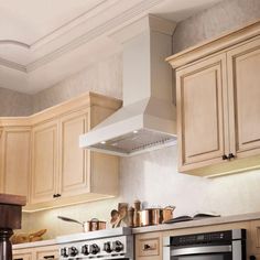 a stove top oven sitting inside of a kitchen next to wooden cabinets and counter tops