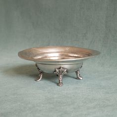 a silver bowl sitting on top of a table