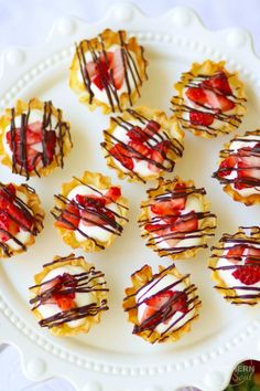 small desserts with strawberries and chocolate drizzle on a white platter