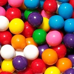 there are many different colored balls in the pile together, and one is multicolored